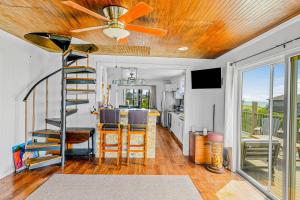 a living room with a ceiling fan and a kitchen at 34 Champlain Unit 1 and Penthouse in Ocean Bay Park