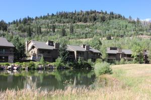 a row of houses next to a body of water at LAKESIDE 1629 townhouse in Park City