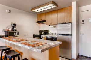 a kitchen with a counter with wine glasses on it at EDELWEISS HAUS 115A condo in Park City