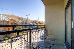 a balcony with two chairs and a table at EDELWEISS HAUS 115A condo in Park City