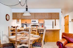 a kitchen and dining room with a table and chairs at FASHION COALITION 402 condo in Park City