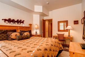 a bedroom with a large bed with a horse headboard at LIFT LODGE 203 condo in Park City