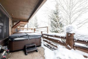 a bed on the back of a house in the snow at COMSTOCK 205 condo in Park City