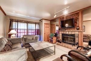 a living room with a fireplace and a tv at PARK STATION 247-1 condo in Park City