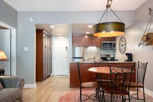 a kitchen and living room with a table and chairs at EDELWEISS HAUS 117 condo in Park City +13 photos