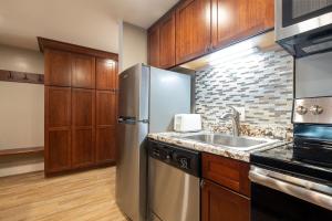 a kitchen with a stainless steel refrigerator and a sink at EDELWEISS HAUS 117 condo in Park City