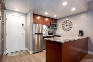 a kitchen with a refrigerator and a counter top at EDELWEISS HAUS 117 condo in Park City