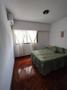 1 dormitorio con 1 cama y 2 ventanas en Departamento en Mendoza Capital en Mendoza