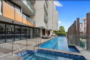 a swimming pool in the middle of a building at Sandy Hill apartment, Sandringham in Sandringham