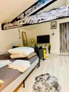 a living room with two beds and a flat screen tv at studio rénové 30m2 a 5 min de la gare in Bordeaux