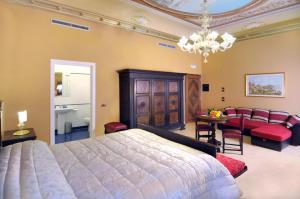 a bedroom with a large bed and a dining room at Antico Portego in Venice