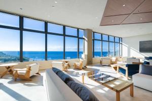 a living room with a lot of windows at TheMana Village in Tosashimizu