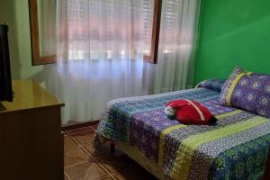 a teddy bear laying on a bed in a room at Colinas in Ciudad de la Costa