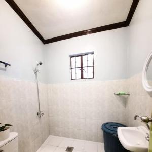 a bathroom with a shower and a sink at Angel's Place Transient House in Tagbilaran City