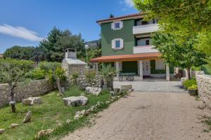 a house with a garden in front of it at Apartments and rooms by the sea Nerezine, Losinj - 11815 in Nerezine