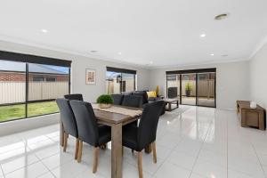 a dining room with a table and chairs at Chifley Place - Cool Suburban Crib! in Sebastopol