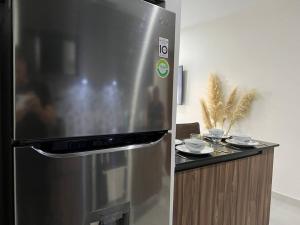 a stainless steel refrigerator in a kitchen with a counter at DEPA BALANTY SUR in Guadalajara