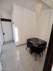 Zimmer mit einem Tisch, 2 Stühlen und einer Tür in der Unterkunft La mejor ubicación de Arica in Arica