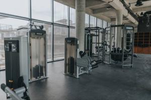 a gym with rows of exercise equipment in a building at Cenote + Swim-Up + Luxury Condo in Tulum