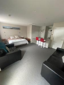 a living room with a bed and a couch at Springfield Motel and Lodge in Springfield