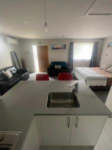 a kitchen with a sink and a room with a bed at Springfield Motel and Lodge in Springfield
