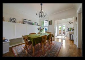 a dining room with a green table and chairs at Big Lux Home w/Beaches, Golden Gate Park & Bridge. in San Francisco