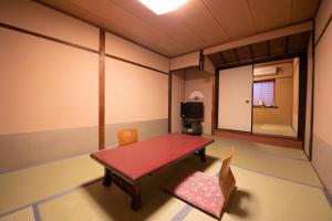 a room with a table and chairs in it at Ohanabo in Kyoto