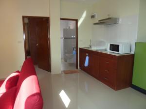 a living room with a microwave on top of a counter at Gib Apartment in Surin