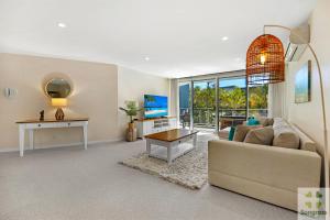 a living room with a couch and a table at Azzura Greens Resort in Gold Coast