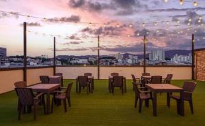 a group of tables and chairs on a rooftop patio at Number25 Hotel Namchuncheon in Chuncheon