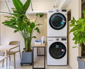 a washer and dryer in a room with plants at Number25 Hotel Namchuncheon in Chuncheon