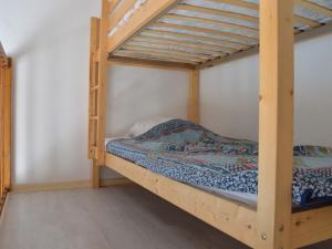 a bunk bed room with a wooden bunk bed frame at Maison Fleury-Saint-Pierre-la-Mer, 3 pièces, 6 personnes - FR-1-229D-582 in Saint Pierre La Mer