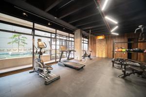 a gym with cardio equipment in a room with windows at Gestión Hotelera - Morph Candelaria in Bogotá