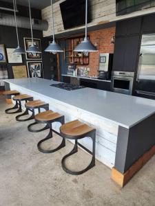 a kitchen with a large counter with stools and a counter top at Studio Apartment - San Antonio Southtown in San Antonio