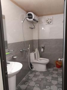 a bathroom with a shower and a toilet and a sink at Hien Thuc Hotel in Ninh Binh