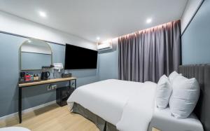 a hotel room with a bed and a mirror at Number25 Hotel Namchuncheon in Chuncheon