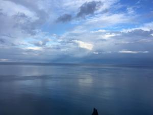 a person standing on the shore of a large body of water at Luna Convento Copanello B&B in Stalettì