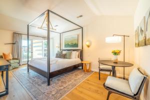 a bedroom with a bed and a table at The Ruse in Healdsburg
