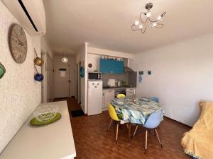kuchnia i jadalnia ze stołem i krzesłami w obiekcie Charmant T2 avec terrasse, climatisation, parking - Valras-Plage - FR-1-701-6 w mieście Valras-Plage