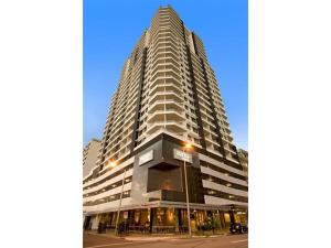 a tall building with a street light in front of it at Pandanas Apt 3 (Darwin CBD, Harbour views) in Darwin