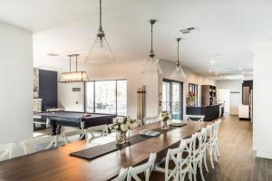 a kitchen and dining room with a table and a pool table at Whitevale Luxury Estate in Lovedale
