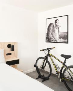 a bike parked next to a bed in a room at Field Station Moab in Moab