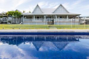 a house with a swimming pool in front of it at River Hamptons in Berri