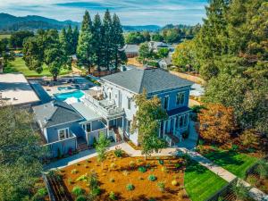 an aerial view of a large blue house with a yard at The Ruse in Healdsburg