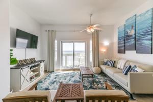 a living room with a couch and a tv at Galveston Luxury High Rise Oceanfront in Galveston