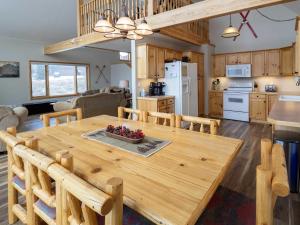 a kitchen and living room with a wooden dining room table at Overlook in Granby