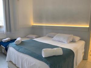 two beds in a room with towels on them at Real Apartments 254 - Barramares flat 2 quartos de luxo com vista espetacular in Rio de Janeiro