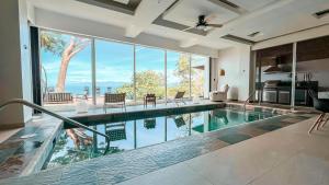 a swimming pool in a house with a large window at Childhood dream house #1 - Private Pool Ocean View in Las Mantas