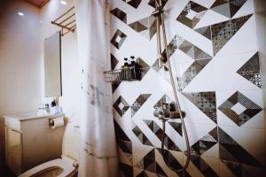 a bathroom with a toilet and a shower at Canal walk inn in Anping