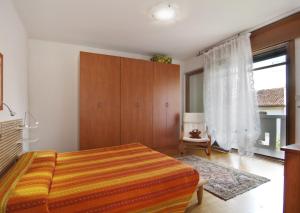 a bedroom with a bed and a large window at Civico 493 B'n'B in Preganziol